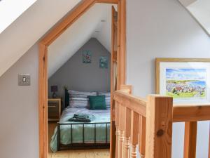 a bedroom with a bed in a attic at Viaduct View in Cullen