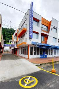 a building with a parking lot in front of it at Hotel Emperador in Barbosa