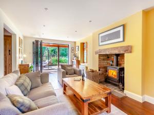 a living room with a couch and a fireplace at Fern Bank Cottage in Parkend