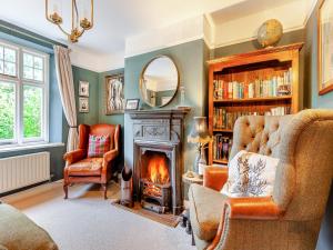 a living room with a fireplace and a fire place at Fern Bank Cottage in Parkend