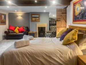 a large white bed in a room with a couch at Manor House Cottage in Highpeak Junction