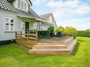 a house with a wooden deck in the yard at Holiday home Asperup V in Asperup