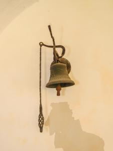 an old bell hanging on a wall at Baroque villa near Bled - Resort Vidmar in Lesce