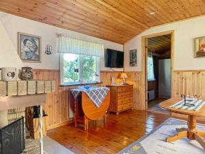 a living room with a table and a wooden ceiling at Holiday home BERGKVARA X in Bergkvara