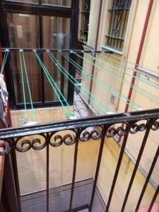 a balcony with green lines on the side of a building at Casa céntrica, en barrio bohemio in Madrid