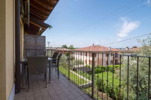 a balcony with a table and chairs and a fence at Apartment in Pacengo - Gardasee 45414 in Pacengo di Lazise