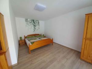a bedroom with a bed and a wooden floor at Apartment in Balatonlelle 45321 in Balatonlelle
