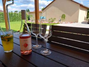 a bottle of wine and two glasses on a table at Apartment in Balatonlelle 45321 in Balatonlelle
