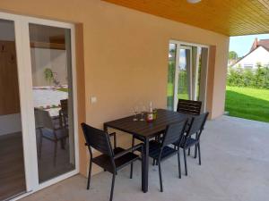 a dining room table and chairs on a patio at Apartment in Balatonlelle 45321 in Balatonlelle +11 photos