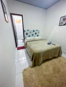 a bedroom with a bed and a rug at Napolitan House in Manaus