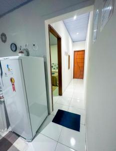 eine Küche mit einem Kühlschrank und Fliesenboden in der Unterkunft Napolitan House in Manaus