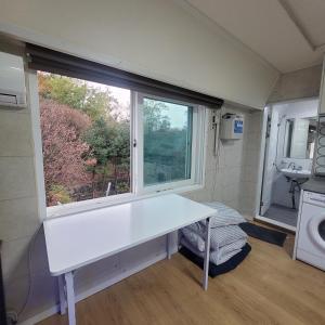 a bathroom with a white sink and a window at Seoul venture town stn #2 7mins, near forest room in Seoul