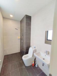 a bathroom with a toilet and a sink and a shower at Troika Kota Bharu Penthouse Homestay 2 rooms in Kota Bharu