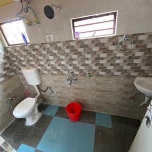 a bathroom with a toilet and a sink at Golden Apple Garden Homestay by StayApart in Kalimpong