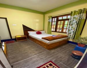 a bedroom with a bed and a window at Golden Apple Garden Homestay by StayApart in Kalimpong