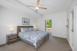 a bedroom with a bed and a ceiling fan at Paradise View @ Bonny Hills in Bonny Hills