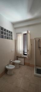 a bathroom with two toilets and a sink and a shower at Guest House Italy 21 -Affittacamere in Sassari
