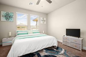 a bedroom with a bed and a flat screen tv at RoundRockLuxuryLivingW/GameRoom in Round Rock