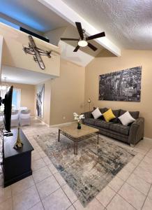 a living room with a couch and a ceiling fan at Spacious 2 Bedroom Townhome/ /15 min from downtown in Houston