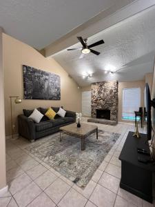 a living room with a couch and a fireplace at Spacious 2 Bedroom Townhome/ /15 min from downtown in Houston