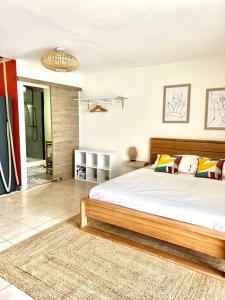 a bedroom with a large bed in a room at Bella Apartment in Fort-de-France