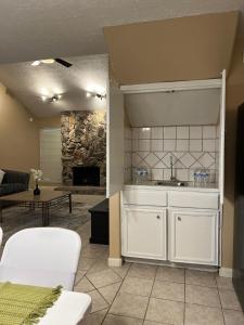a kitchen with a sink and a living room at Spacious 2 Bedroom Townhome/ /15 min from downtown in Houston