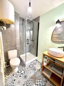 a bathroom with a shower and a toilet and a sink at Bella Apartment in Fort-de-France