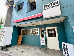 a blue building with a sign for a restaurant at TenTen Guesthouse in Asakusa in Tokyo