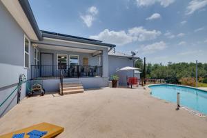 a patio with a swimming pool and a house at 1-Story Hill Country Home Near Fiesta with Pool! in San Antonio