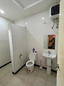 a bathroom with a toilet and a sink at Lovadek Spacious Apartment in Lagos