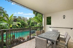 a balcony with a table and chairs and a view of the water at Club Wyndham Cairns in Cairns