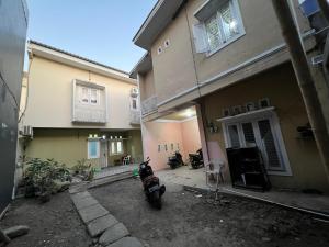 a motorcycle parked in front of a house at Hotel O Anugrah Homestay Syariah in Makassar