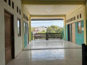 an empty hallway of a house with a balcony at SPOT ON 93037 Nova Jaya Homestay Syariah in Lamongan