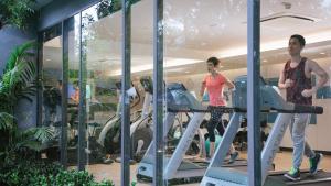 a group of people running on a treadmill in a gym at Holiday Inn Express Bangkok Soi Soonvijai, an IHG Hotel in Bangkok