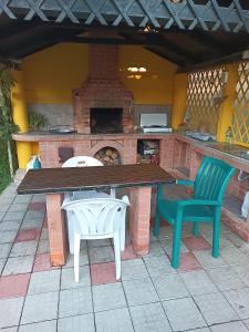 a patio with a table and two chairs and a fireplace at La Prietenicu in Murighiol