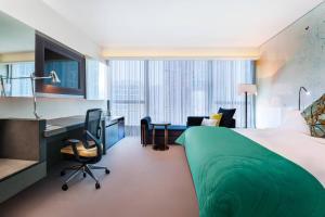 a hotel room with a bed and a desk at W Hong Kong in Hong Kong