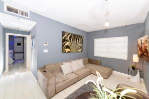 a living room with a couch and a wall at Sunny Days Apartments in Miami Beach