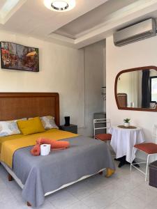 a bedroom with a bed with a teddy bear on it at Caribbean Queen in Cancún