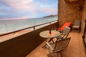 a table and chairs on a balcony with a view of the beach at Mirador Canteras-Auditorio in Las Palmas de Gran Canaria