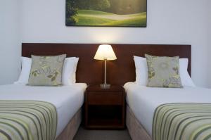 Postel nebo postele na pokoji v ubytování Club Wyndham Port Stephens