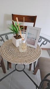 a table with a laptop and a plant on it at Airlie Seaview Apartments in Airlie Beach