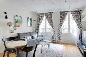 a living room with a couch and a table at Saint-Honoré Beautiful apartment 4 people in Paris