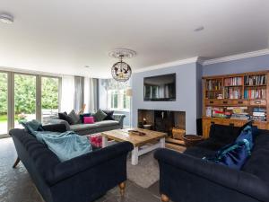 a living room with two couches and a table at Vallis Oak Villa in Frome