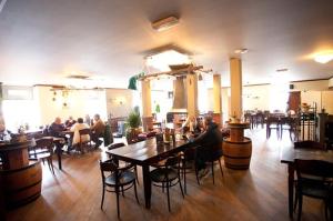 a restaurant with people sitting at tables in a room at Holiday Home Maridu Wellness in Arnhem