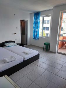 a bedroom with a large bed and a window at Fa Mol in Sunny Beach