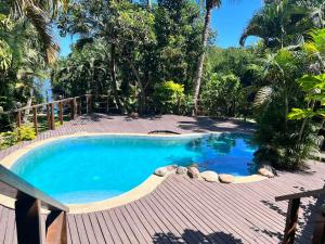 a swimming pool with a wooden deck and a swimming poolvisor at Tropical Garden-04-G in Nadi