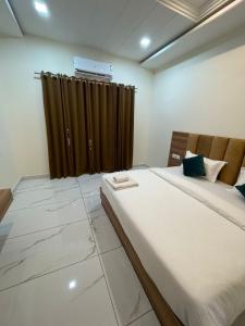 a bedroom with a large bed and a curtain at HOTEL VIEW in Govardhan