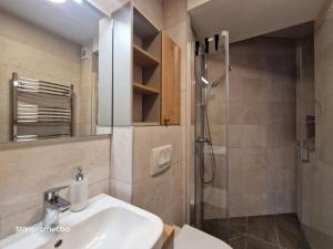 a bathroom with a sink and a shower at Sun&Snow Jahorina in Jahorina