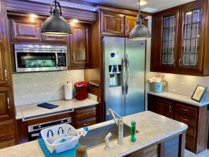 a kitchen with a refrigerator and a sink at Happy Hedgehog River Views Hot Tub Private in Ahwahnee