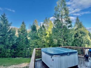 a hot tub on a deck with trees at Honeybee Hive HOT TUB BBQ 8 minutes to Bass Lake Sleeps up to 6 in North Fork